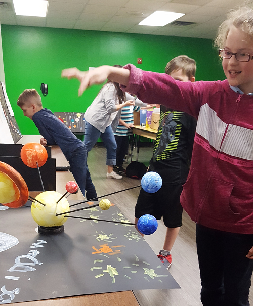 Girl working on planet display